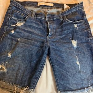 Partially distressed knee length denim shorts